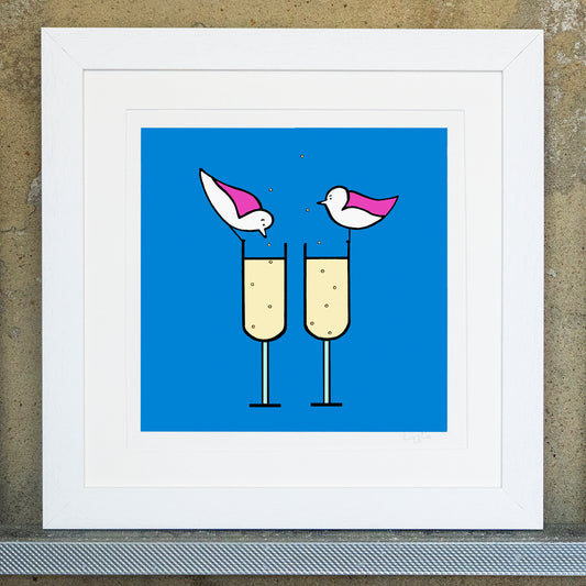 Giclee original artwork print in a white mounted frame. Two pink winged seagulls are perched on the rim of two glasses of fizz, the bubbles are floating from the bottom of the glass out to the top. The background is bright blue. One seagull is peering into the glass.