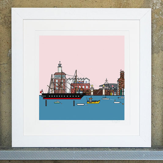 Giclee original artwork print in a white mounted frame. The portsmouth historic dockyard main gate and wall is in the distance of the HMS Victory ship in the sea surrounded by small boats. In the distance you can see the prince of wales carrier, boathouse 4, sculpture and a british flag.