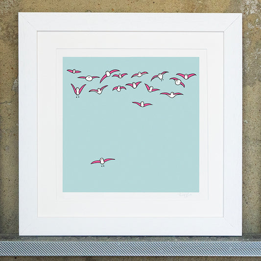 original square print of multiple pink seagulls flying in the sky with one pink seagull flying on it's own at the bottom. The background is a pale blue with a white mounted frame