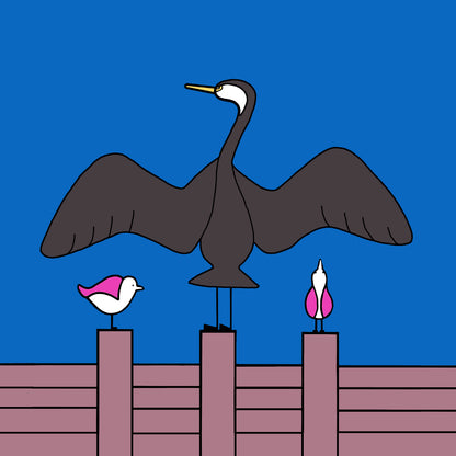 A groyne has a cormorant with it's wings spread out. Either side are two pink winged seagulls also perched on the groyne, one is looking up at the wing of the cormorant and the other to the side. the sky is bright blue.