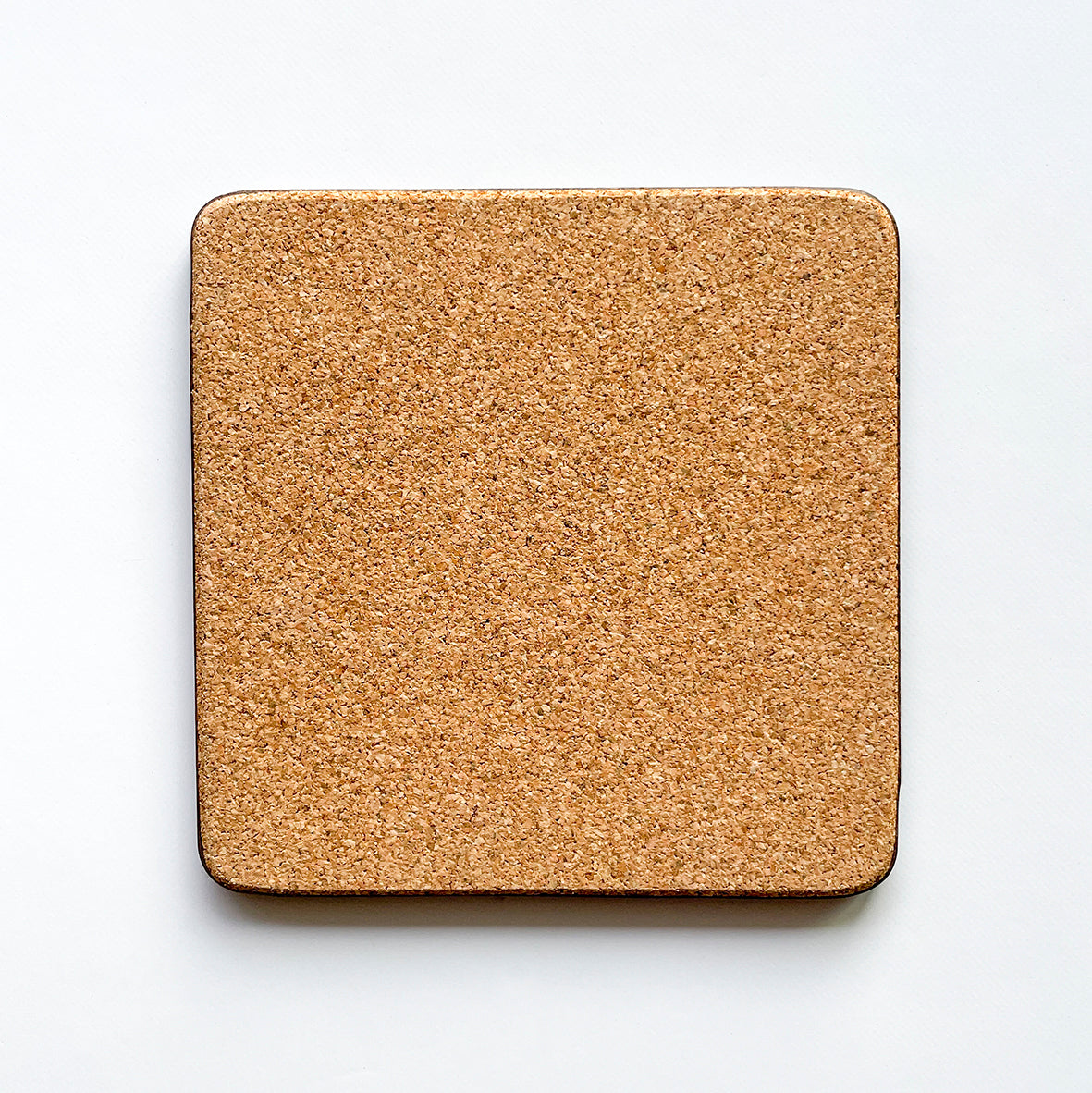 Back of the coaster made of eucaplyptus board with cork, the back is textured and a beige brown colour.