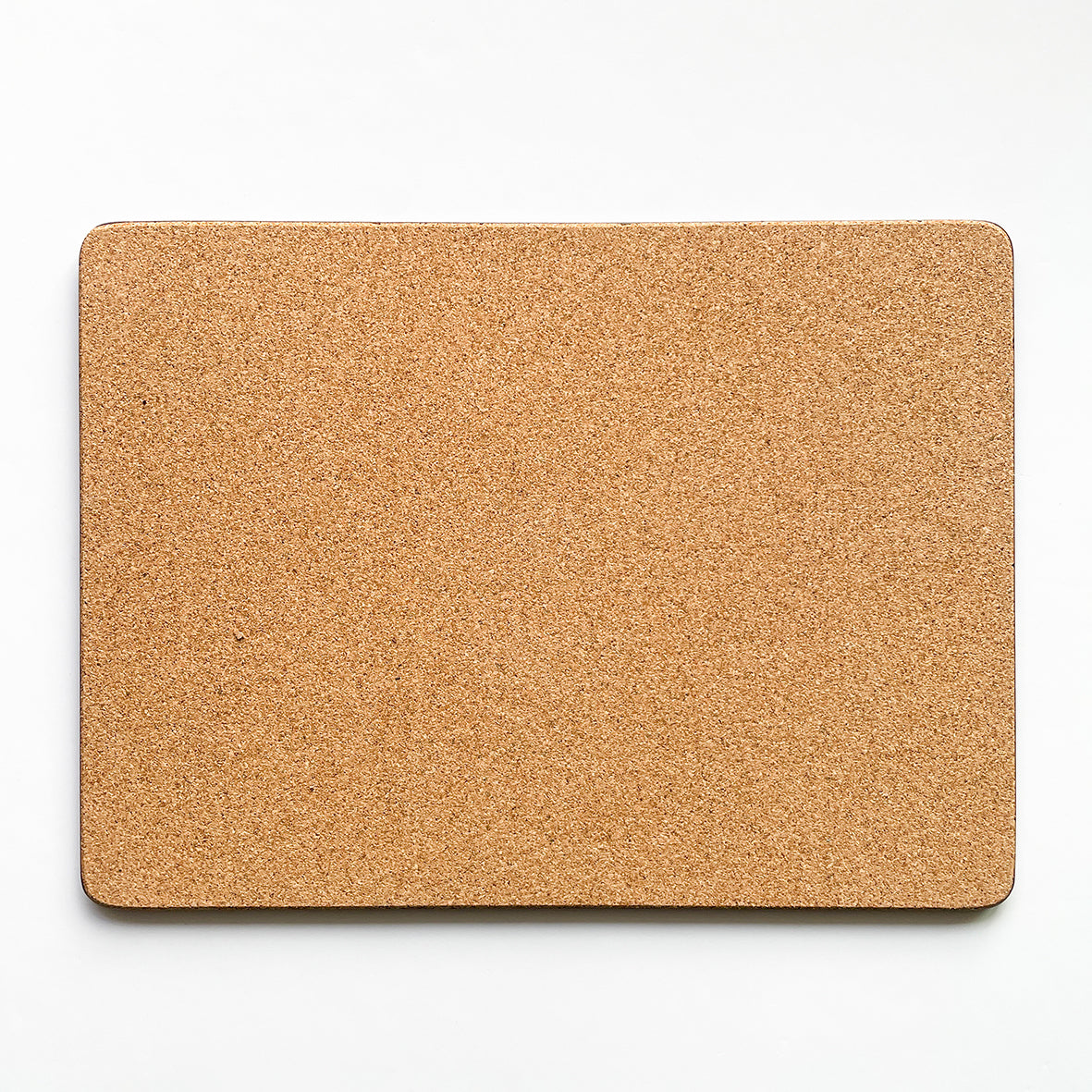 Back of the placemat made of eucaplyptus board with cork, the back is textured and a beige brown colour.