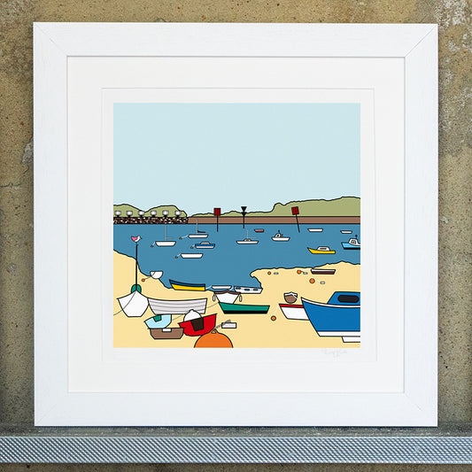 Giclee original artwork print in a white mounted frame. Multiple boats are in the harbour, some are on the sand and some in the water. The boats are all different sizes and colours with buoys. In the distance are warning groynes and green landscape with a pale blue sky. One of the small boats on the sand has a small pink winged bird perched on top of the sailing pole.