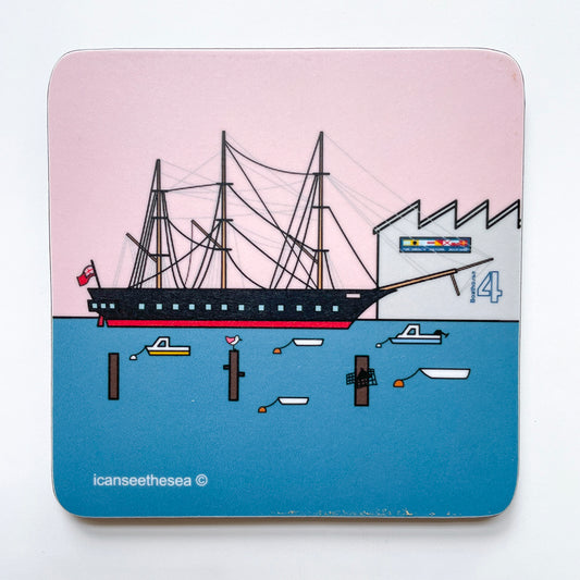 coaster with original painting design of the hms warrior with pink sky and bright blue sea, with boathouse 4 and small fishing boats dotted in front. A small pink wing seagull sits ontop on a groyne. I can see the sea text is on the bottom left 