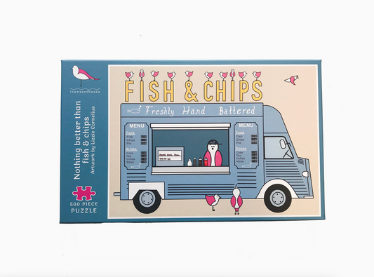 The front of a jigsaw package is displayed on a white background. The jigsaw package says nothing better than fish & chips artwork by Lizzie Cornelius and 500 piece puzzle. On the right is a painting of a fish and chips van with lots of pink winged seagulls. The van is parked sideways with signage of freshly hand battered, a menu and a pink winged seagull serving wearing a cap inside the van. The background is a pale beige and the van is a blue-grey, other colours are pink and yellow.