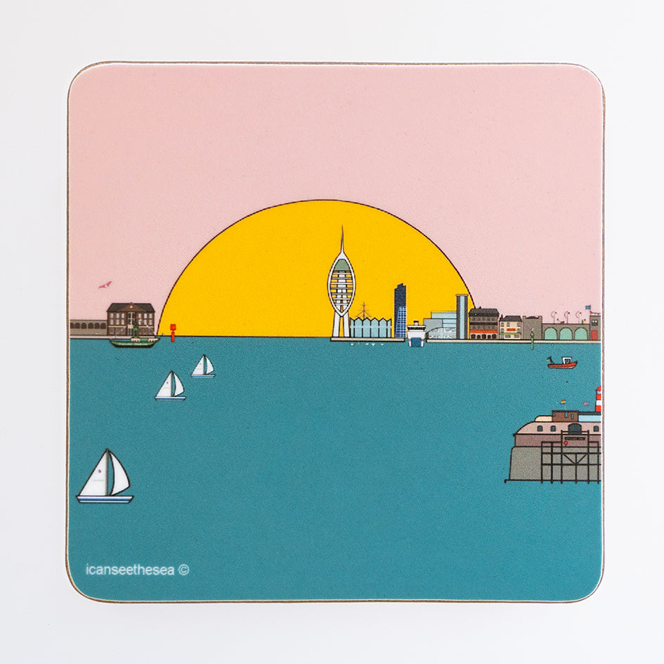 A coaster of a painting of Portsmouth and Gosport. The sky is pale pink with a big semi circle yellow sun on the horizon, the sea is blue teal colour and in the water are sailing and fishing boats with a fort. On the horizon to the right is portsmouth with the spinnaker tower, lipstick tower, warrior, old portsmouth, round tower, square tower and the isle of wight ferry parked. To the left is gosport arches and buildings. In the sky is a pink winged seagull flying.