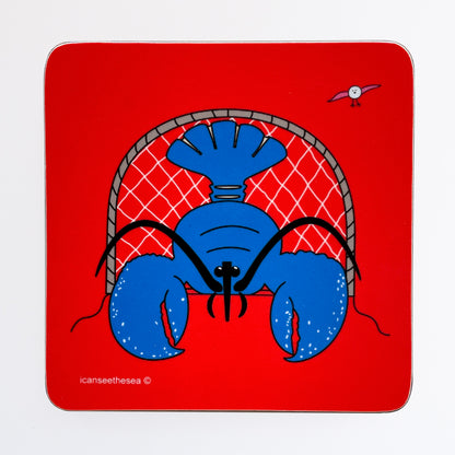 A coaster of a painting of a lobster. The background is bright red with a bright blue lobster facing forwards with a net behind it. The lobster has black beady eyes with two large claws sticking out. in the background is a pink winged seagull flying.