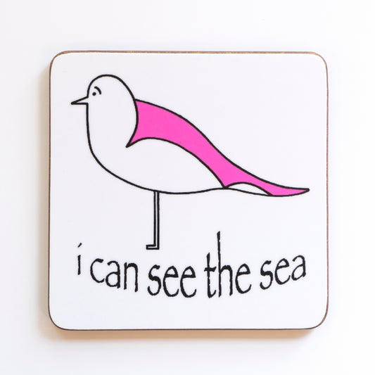 coaster with a pink winged seagull and I can see the sea text